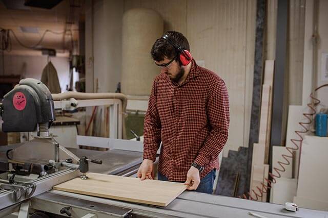 Furniture builder cutting wood