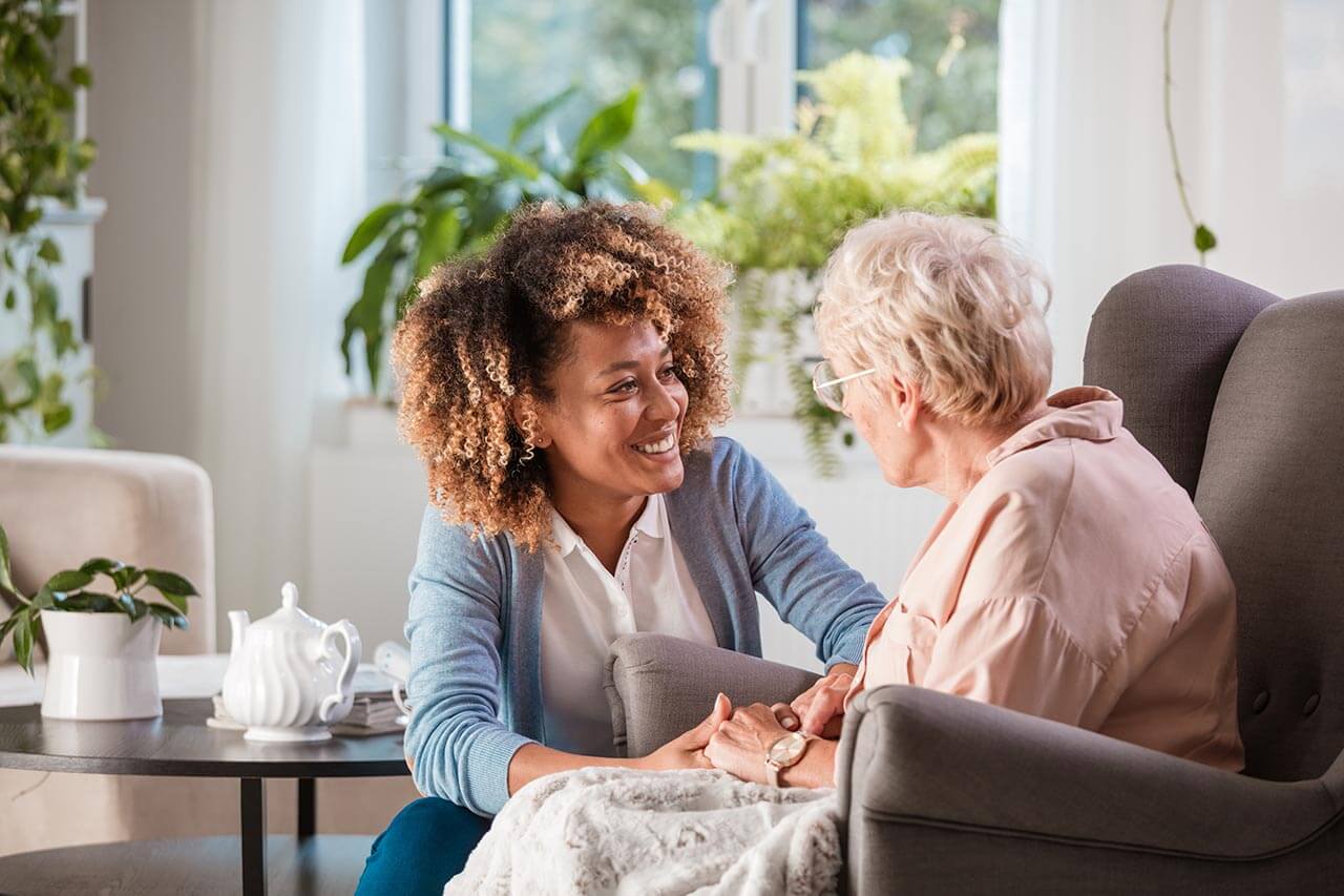 Career talking to a resident in a care home