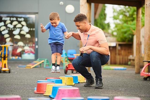 Nursery worker playing with a child