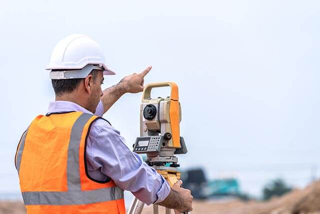 Engineer surveying construction site