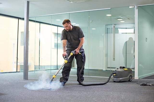 Cleaning contractor using steamer