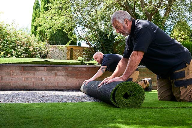 Gardeners laying turf