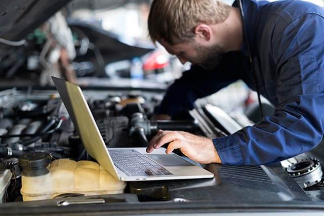 Mechanic working on laptop