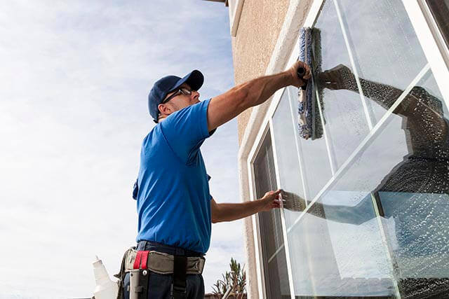 Contractor cleaning windows