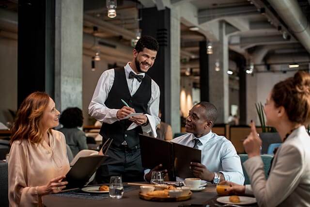 Waiter taking an order at a table in a restaurant