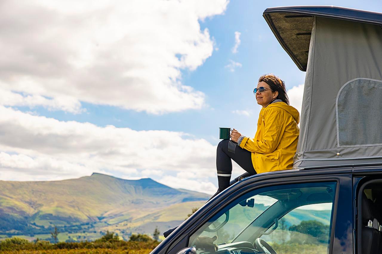 Person with camper van admiring scenic view
