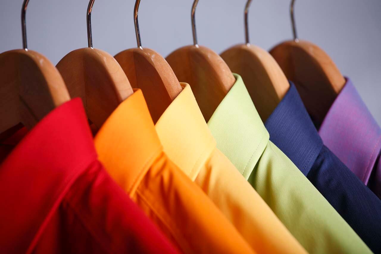 Colourful shirts on a rail